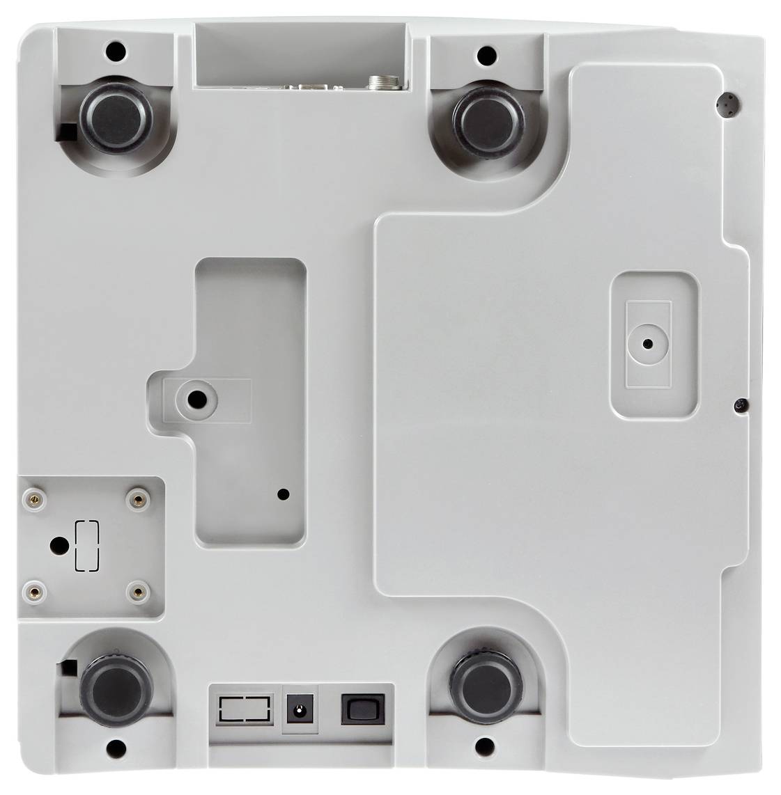 Dolny widok projektora z czterema gumowymi stopkami w narożnikach, wieloma złączami i punktami mocowania w prostokątnej obudowie.