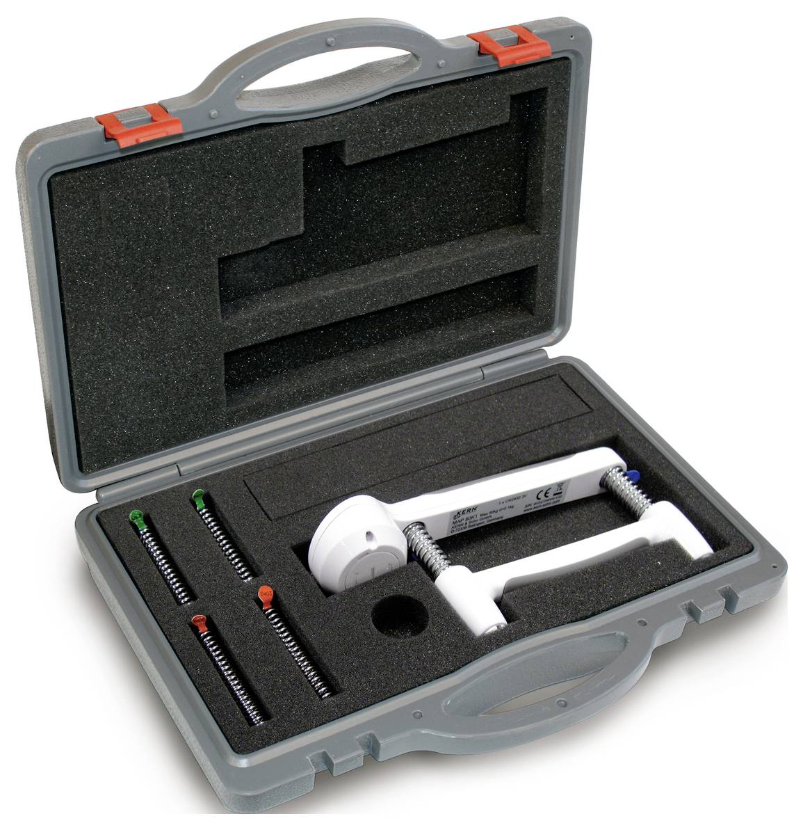 Otwarty plastikowy kufer z wkładką piankową, prezentujący dynamometr ręczny i trzy różne sprężyny pomiarowe.