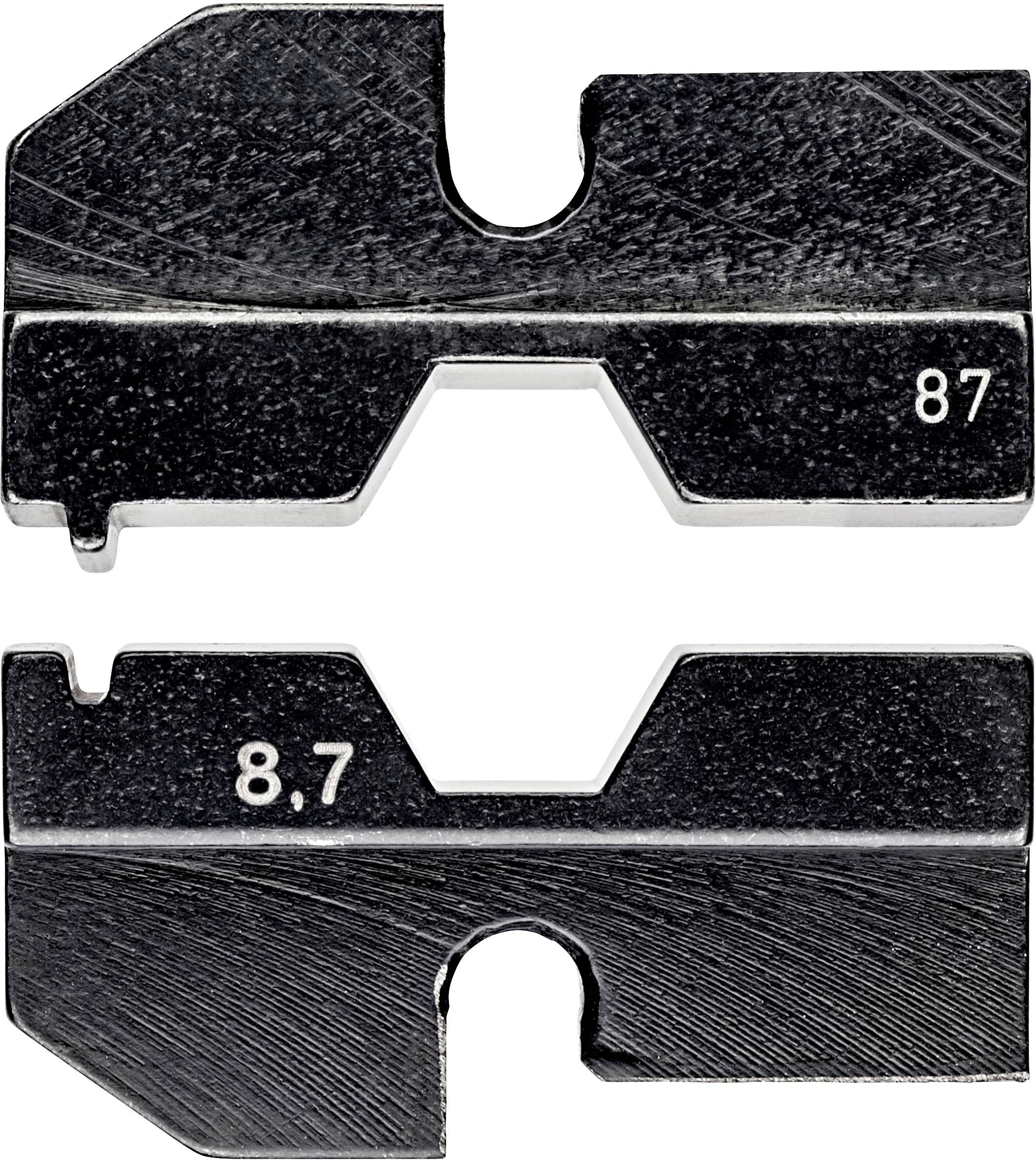Dwie czarne metalowe płyty z wycięciami, oznaczone numerami '87' i '8,7', leżą równolegle względem siebie.