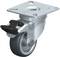 Rolka obrotowa z szarą gumową bieżnią, stabilną metalową płytą montażową i hamulcem postojowym, przeznaczona do mebli lub urządzeń.