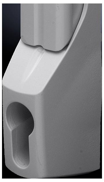 Zbliżenie szarego, metalowego elementu z kształtem przypominającym świecę wycięciem, prawdopodobnie będącego częścią większego urządzenia technicznego.