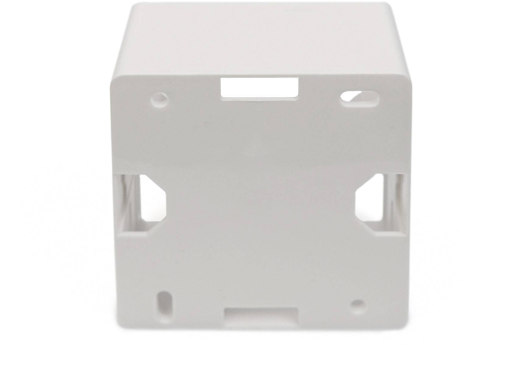 Biały plastikowy sześcian z otworami i wycięciami, prawdopodobnie obudowa lub uchwyt w zastosowaniu technicznym.