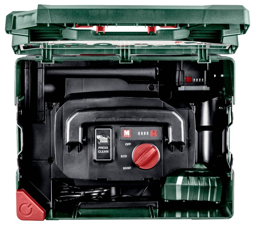 Otwarty zielony przybornik z narzędziami elektrycznymi, pokazujący urządzenie z czerwonymi pokrętłami ustawień oznaczonymi 'ECO' i 'BOOST' oraz przyciskiem 'PRESS CLEAN'.