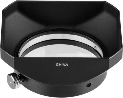 Czarna, sześciokątna metalowa oprawa z pokrętłem z boku, w której środku osadzona jest okrągła szklana soczewka.