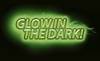 Tekst 'Glow in the Dark!' świeci zielonym blaskiem na czarnym tle.