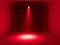 Pusty pokój z czerwonym promieniem światła skierowanym na podłogę. Tło jest ciemne.