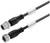 Dwa czarne kable koncentryczne z metalowymi wtyczkami i osłonami z tworzywa sztucznego na końcach, odpowiednie do zastosowań przemysłowych i elektronicznych.