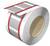 Duża rolka z metalowej taśmy owinięta czerwonymi paskami, z paskami papieru na wierzchu, prawdopodobnie do celów pakowania.