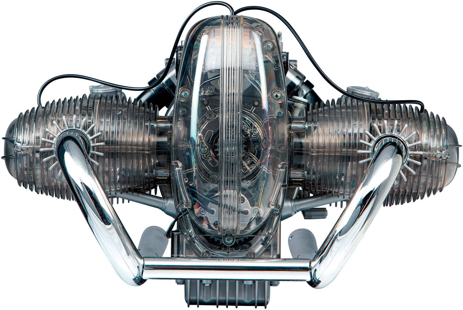 Blok silnika widziany z góry z widocznymi głowicami cylindrów i rurami wydechowymi, w stylistyce techniczno-przemysłowej.