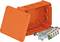 Pomarańczowa puszka rozdzielcza ze zdjętą pokrywą, otworami wewnątrz oraz wyjmowalnym blokiem zaciskowym.