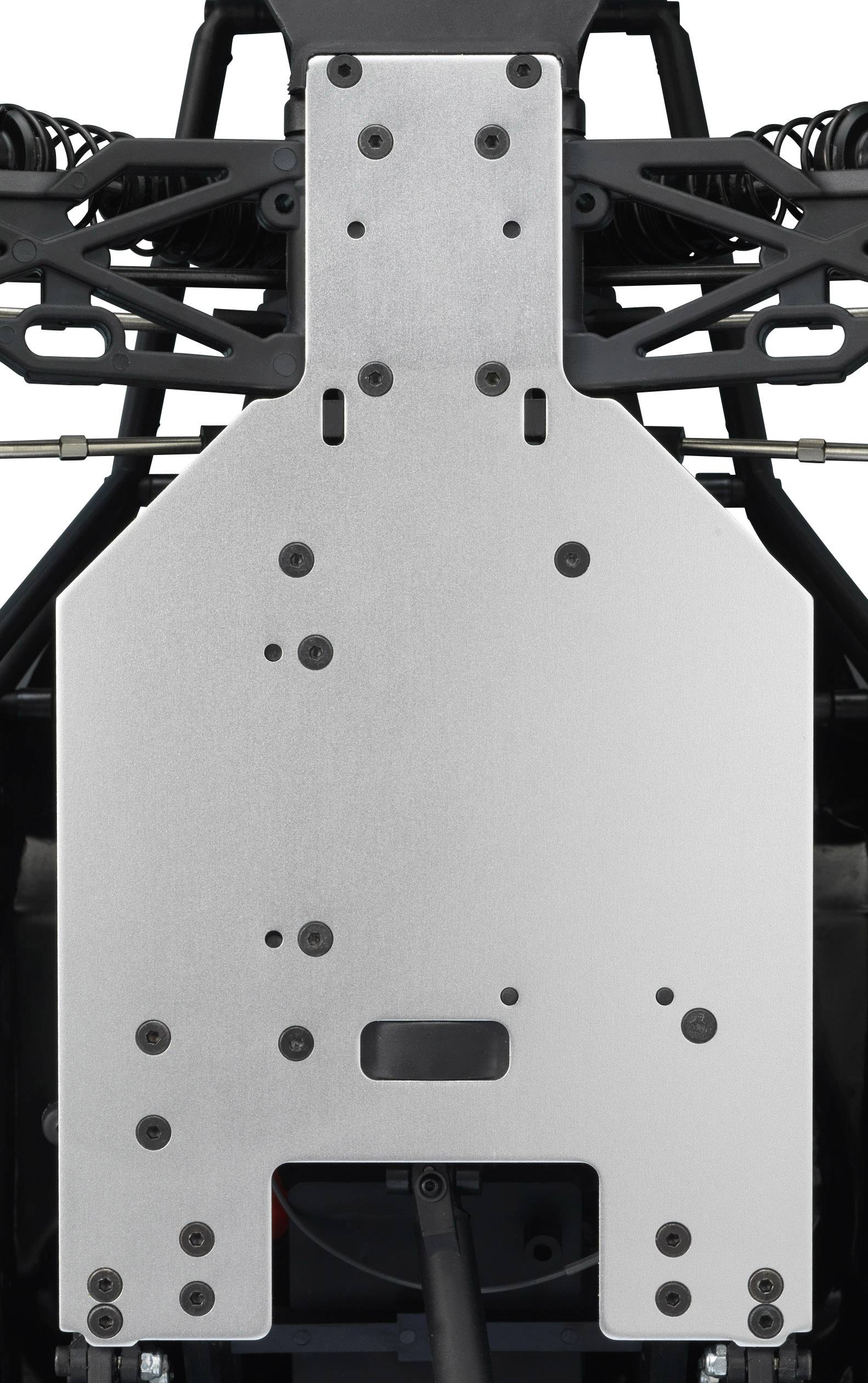 Zbliżenie metalowej podłogi pojazdu z wieloma otworami na śruby i elementami zawieszenia.