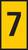 Żółta tarcza z czarną cyfrą '7' na niej.