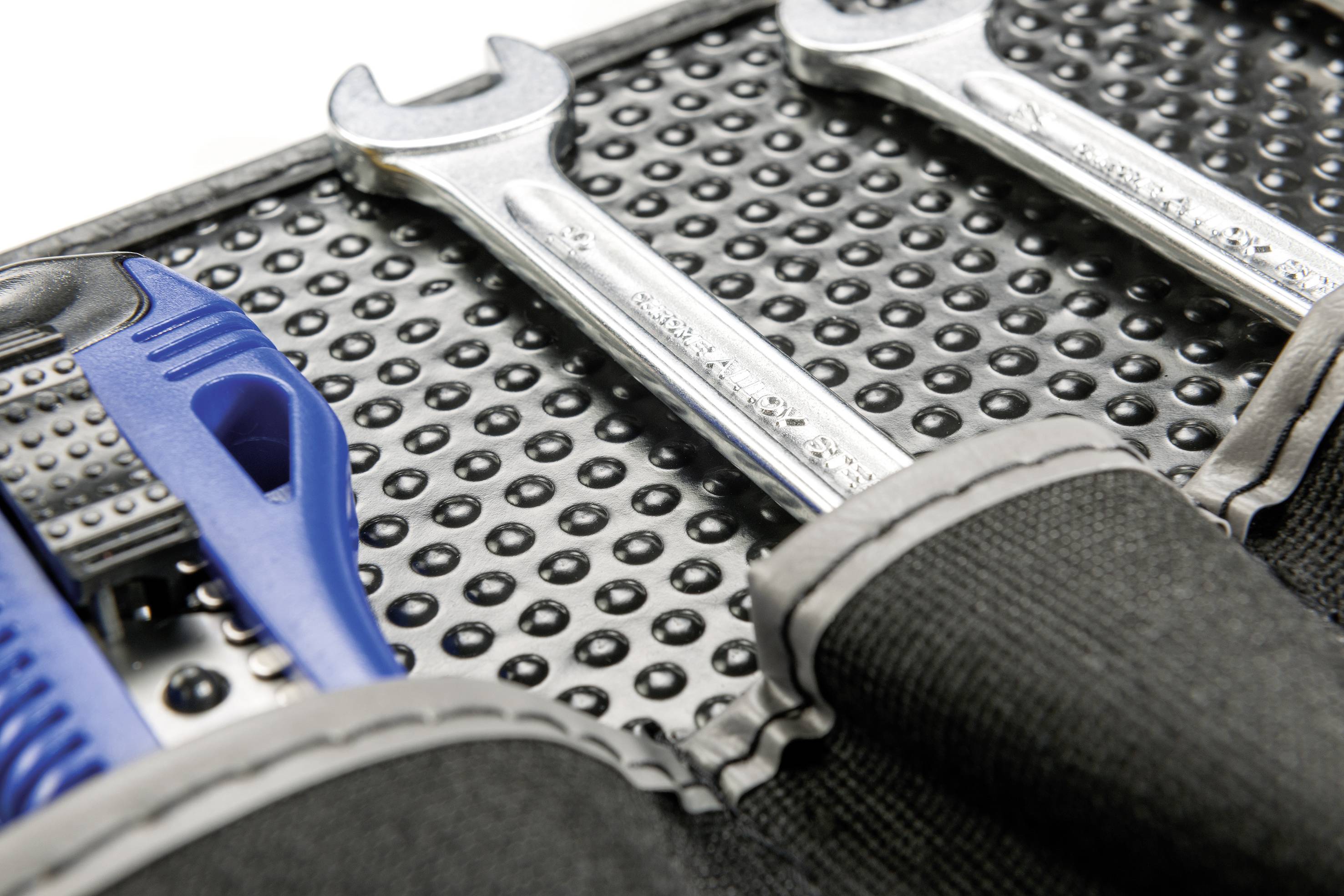 Narzędzia w otwartej torbie: Niebieski śrubokręt i srebrny klucz na strukturalnym podłożu.