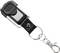 Brelok do kluczy z metalową częścią, czarną plastikową nakładką oraz kółkiem zawieszającym jest przedstawiony na białym tle.