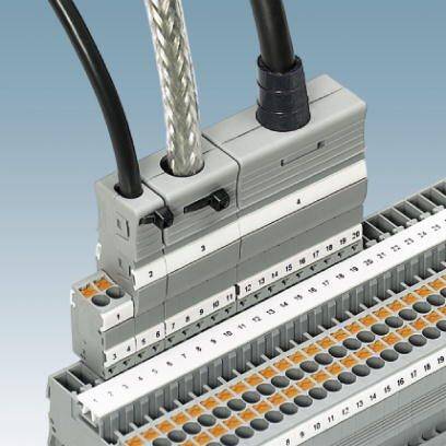 Blok zacisków z numerowanymi przyłączami i dwoma wtpiętymi kablami, zamontowany na szynie DIN. Służy do połączeń elektrycznych.
