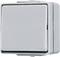 Szary przełącznik światła do montażu naściennego, kwadratowy z zaokrąglonymi narożnikami.