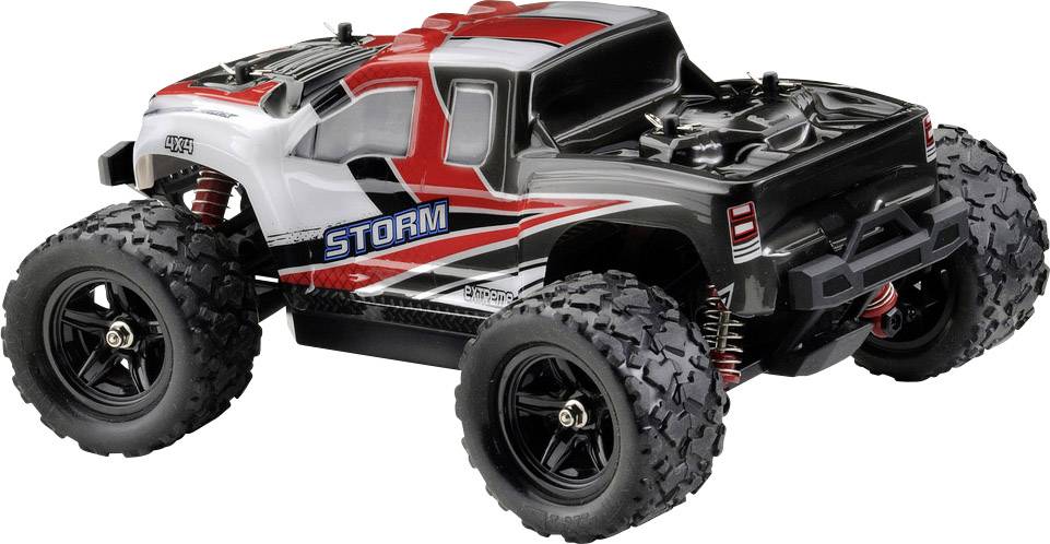Zabawkowa ciężarówka w stylu terenowym w kolorach czarnym, białym i czerwonym z napisem 'STORM' na boku i dużymi oponami do jazdy w terenie.