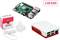 Zestaw Raspberry Pi z 2 GB RAM: płytka, biało-czerwona obudowa, zasilacz i opakowanie z logo Raspberry. Idealny do projektów elektronicznych.