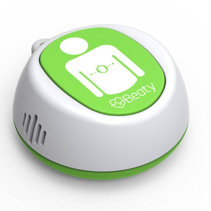 Mały, okrągły, przenośny sprzęt medyczny z zielonym symbolem stylizowanej sylwetki ciała oraz logo 'Beaty'.