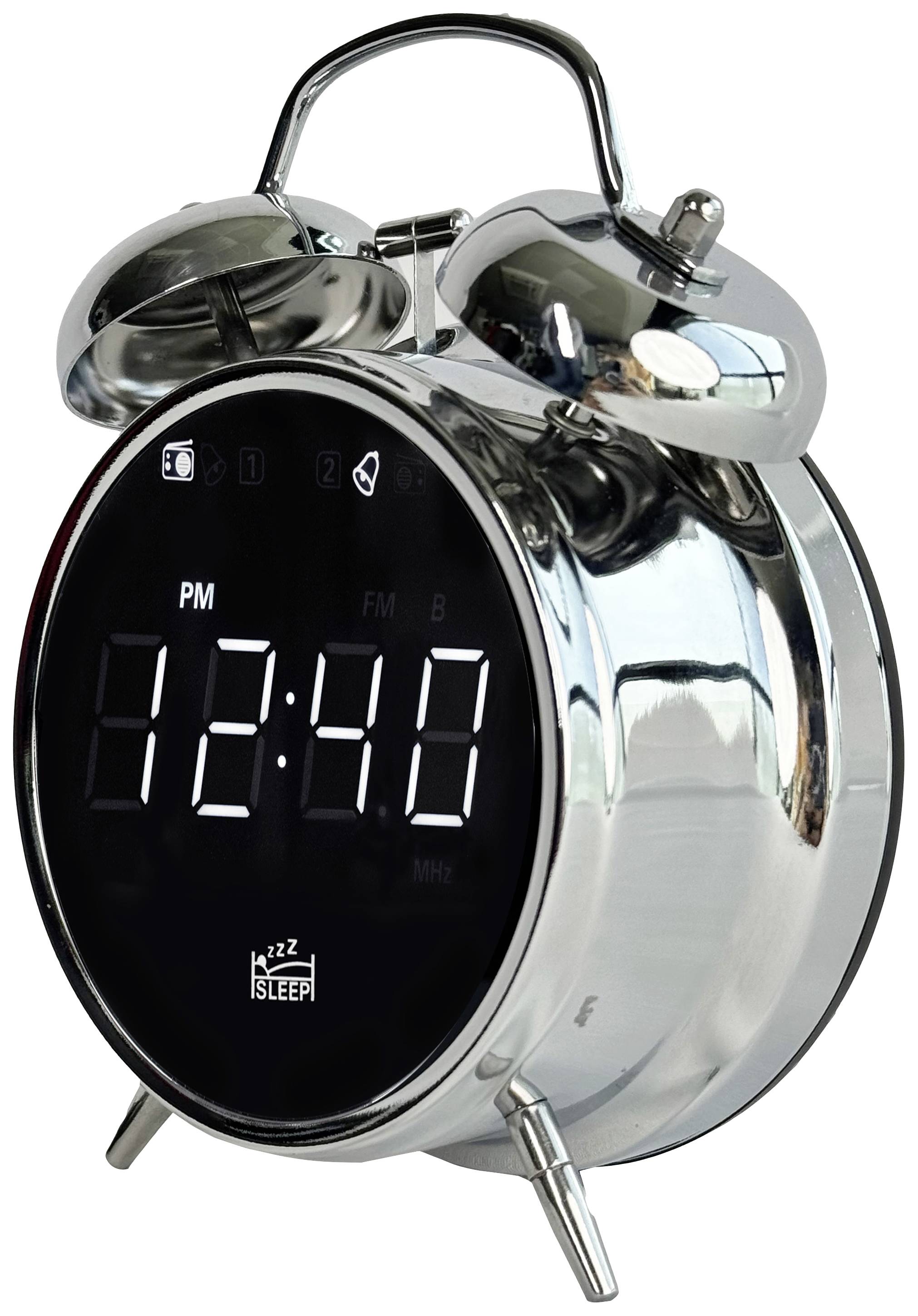 Srebrny budzik o analogowym wyglądzie wyświetla godzinę 12:40 w formie cyfrowej. Na górze umieszczone są dwa dzwonki z młoteczkiem.