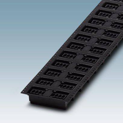 Czarna, podłużna płyta z kilkoma prostokątnymi wgłębieniami ułożonymi w rzędzie, na niebieskim tle.