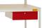 Stół z białą powierzchnią i czerwoną szufladą poniżej.