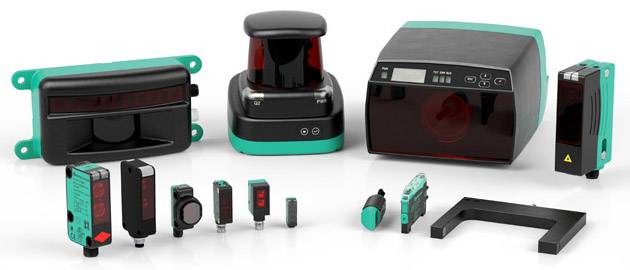 Kilka przemysłowych czujników i urządzeń w różnych formach i rozmiarach, ułożonych na białej powierzchni. Produkty w kolorach czarnym i turkusowym.