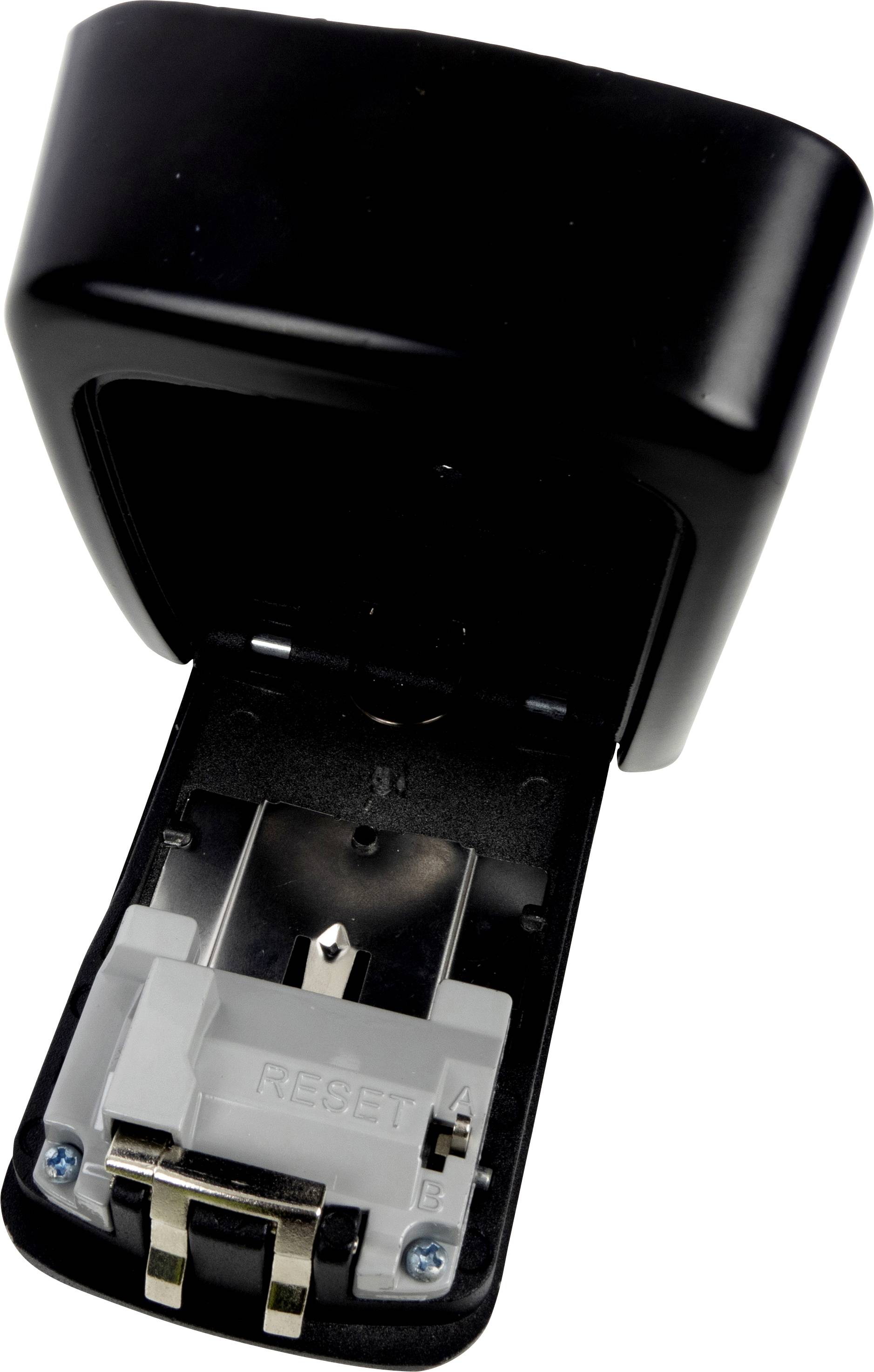 Czarny ładowarka do baterii z otwartą pokrywą ujawnia komorę baterii i styki. Widoczne są przyciski 'A' i 'B'.