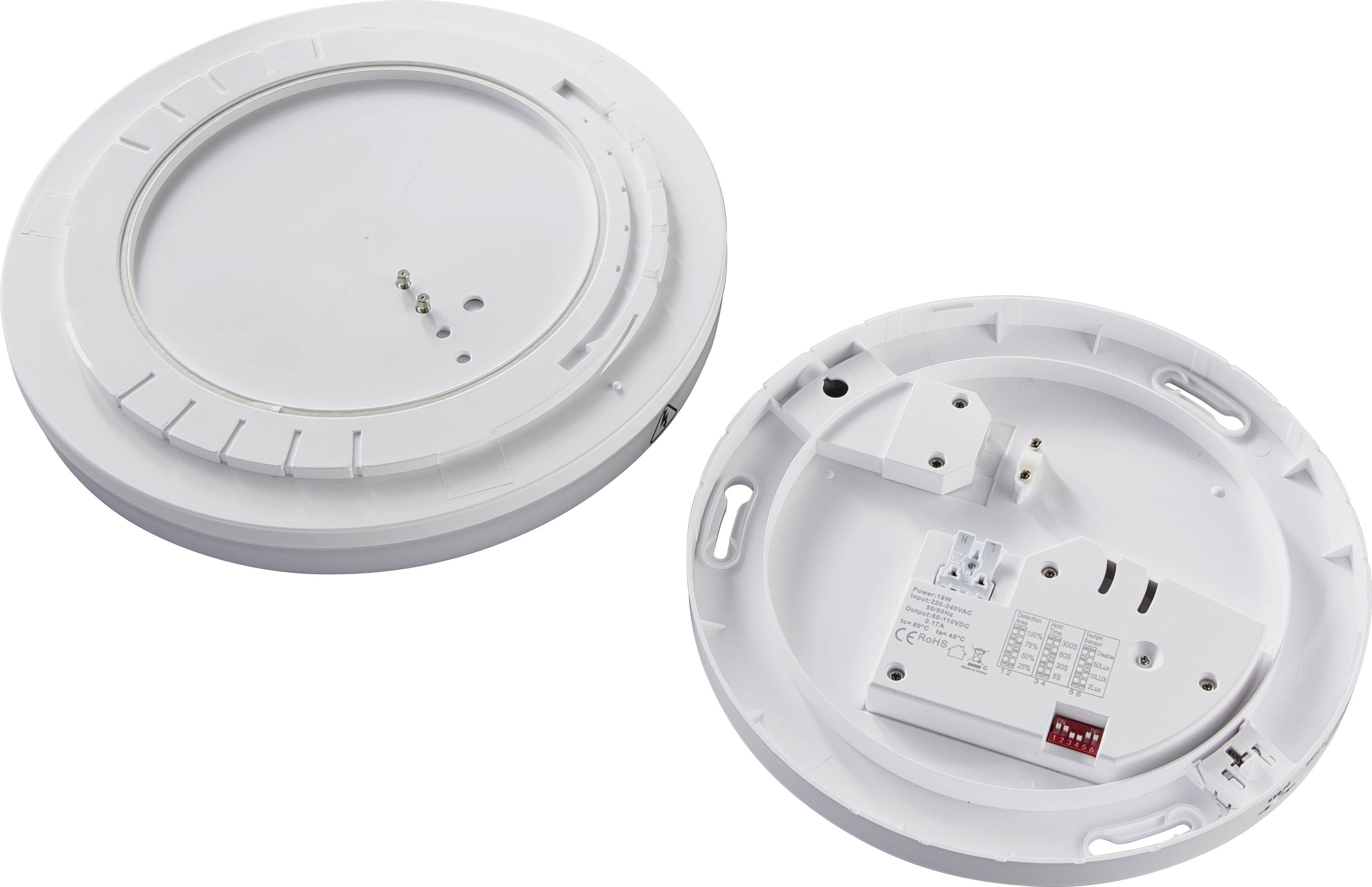 Dwa okrągłe czujniki dymu, otwarte i leżące płasko, ukazują wewnętrzne komponenty do montażu i eksploatacji.