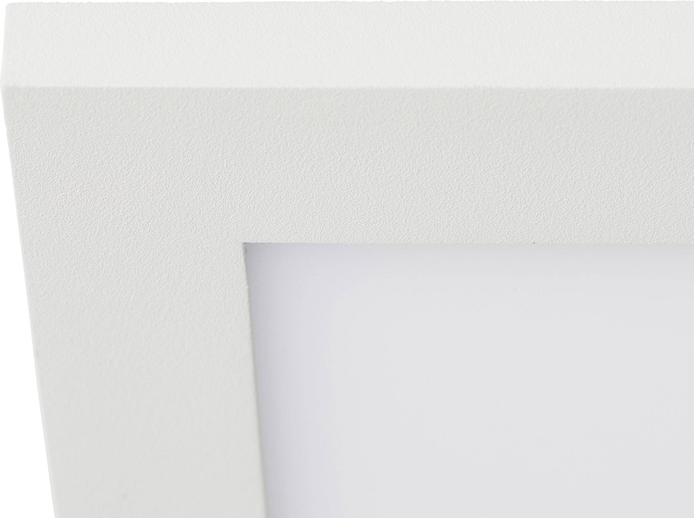 Biały drewniany ramka, zbliżenie na górny lewy róg. Ramka zawiera obraz, który nie jest widoczny.