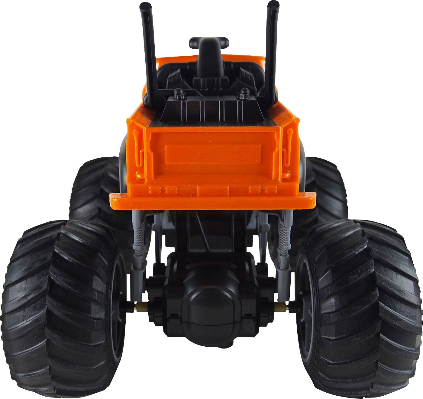 Plastikowy traktor zabawkowy w jaskrawym pomarańczowym kolorze, widziany od tyłu. Widoczne są duże, bieżnikowane opony i kierownica.