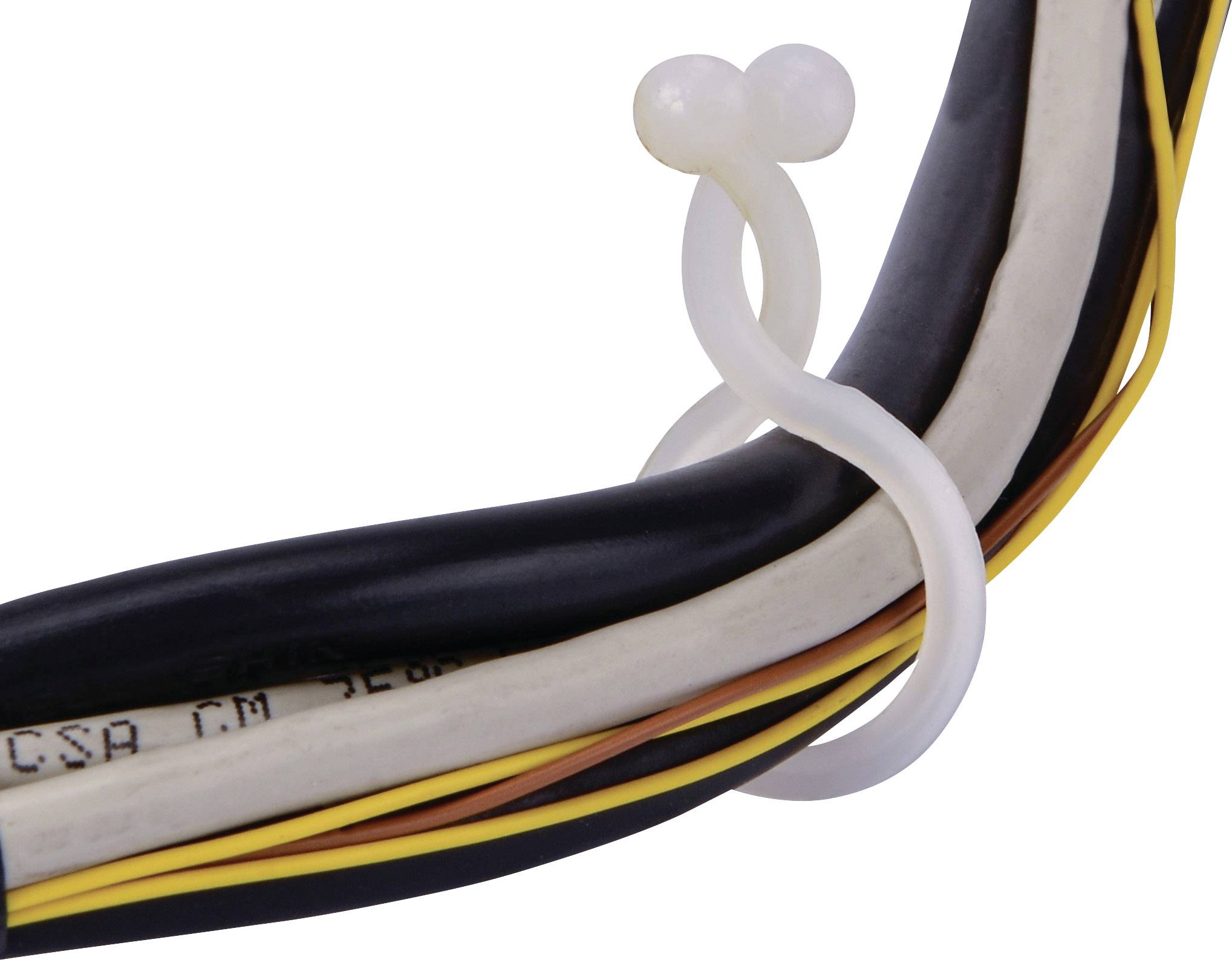 Wiązka kabli jest spięta białą plastikową opaską zaciskową. Widoczne są różne kable w kolorach czarnym, białym i żółtym.
