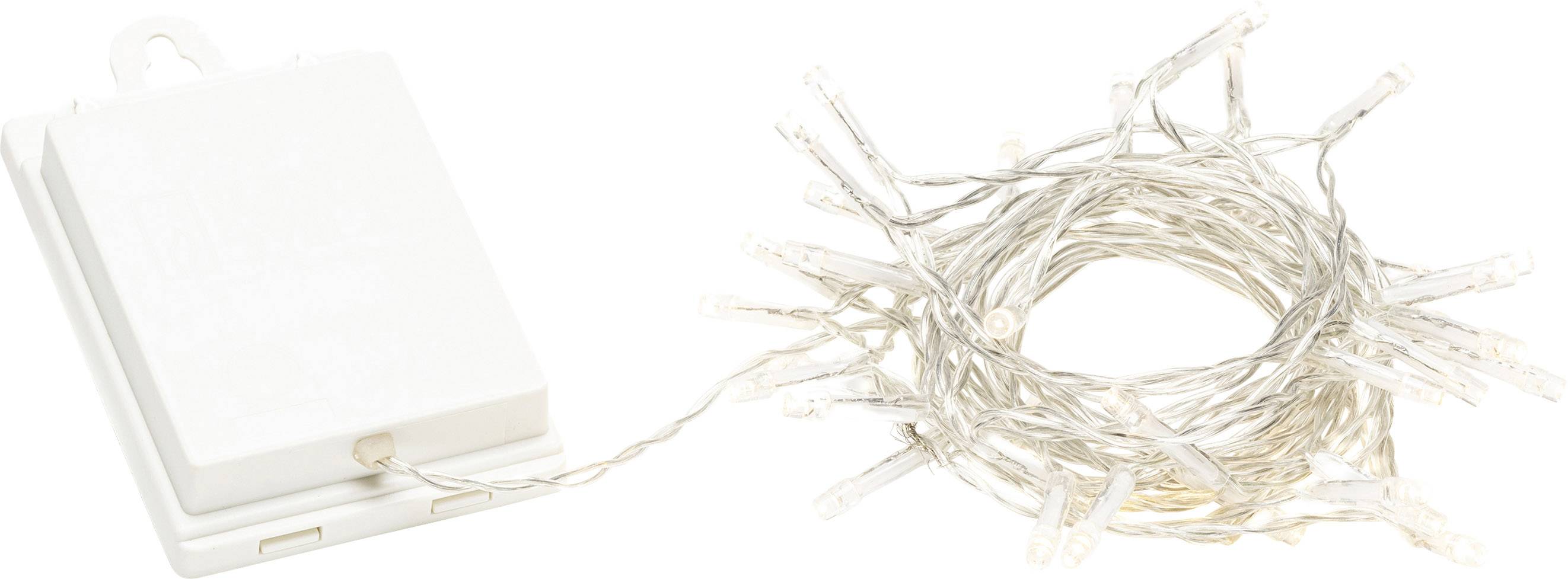 Łańcuch świetlny zasilany baterią z przezroczystymi przewodami, luźno rozłożony na stole, obok białej obudowy baterii.