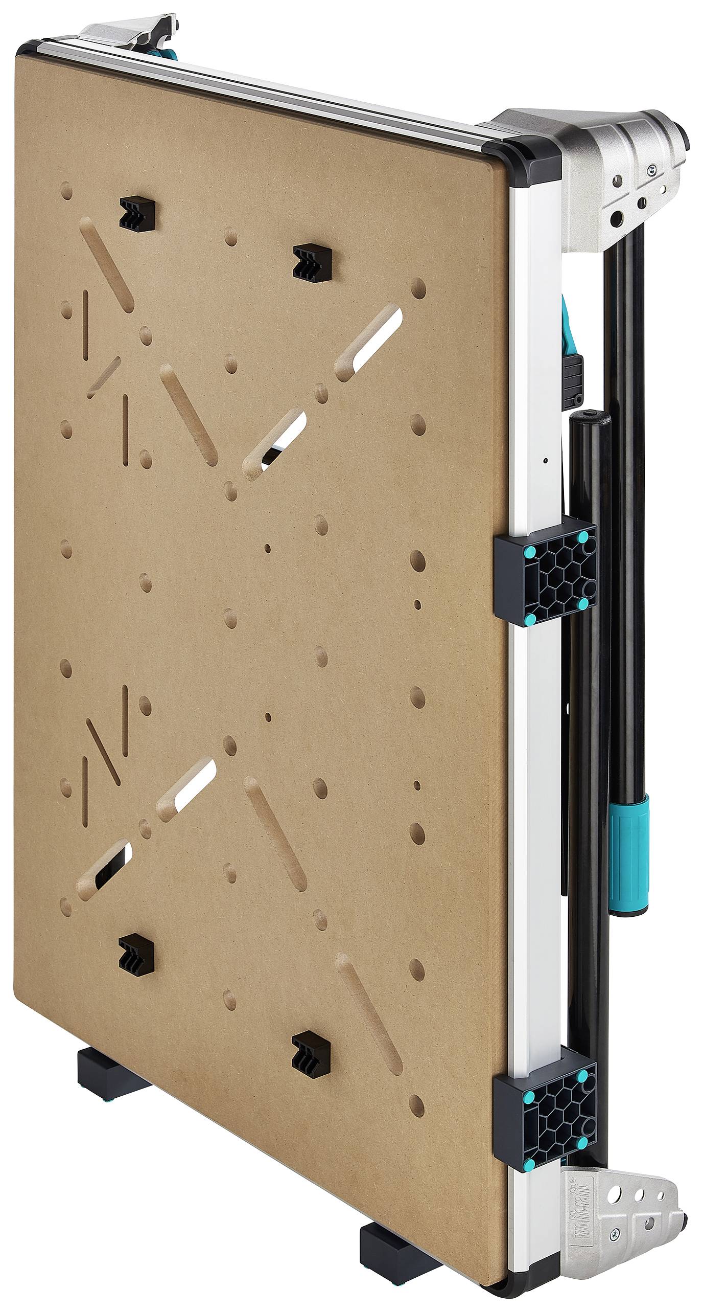 Składany stół roboczy, w pozycji złożonej. Drewniana płyta z wieloma otworami, metalowa rama i czarne nóżki.