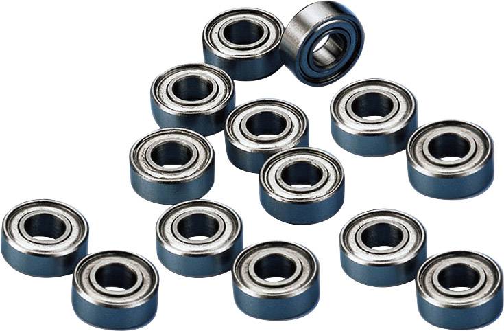 Trzynaście małych łożysk tocznych na białym tle, ułożonych w nieregularny sposób, prezentujących metalowe pierścienie wewnętrzne i zewnętrzne.