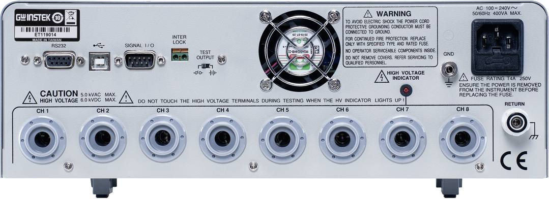 Tylna strona elektrycznego urządzenia pomiarowego z wieloma złączami i wentylatorem. Na obudowie widoczne są ostrzeżenia i szczegóły techniczne.