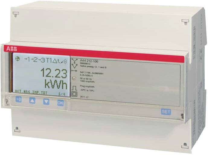 Cyfrowy licznik energii elektrycznej wyświetla '12,23 kWh' na wyświetlaczu. Na górze widoczne są symbole i tekst.