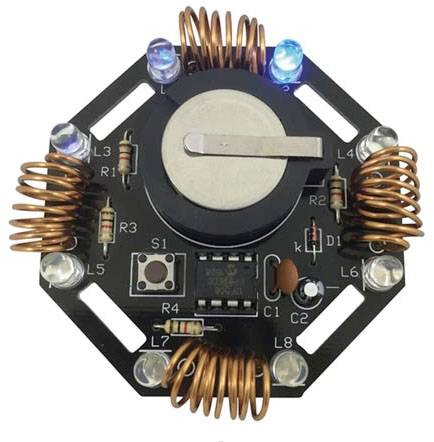 'Elektroniczny moduł obwodu z cewkami i diodami LED na sześciokątnej płytce drukowanej, przedstawiający rozmieszczenie i projekt komponentów.'