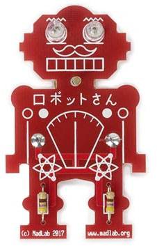 Czerwona płytka drukowana w kształcie robota z świecącymi oczami i japońskim tekstem 'ロボットさん'. Widoczne komponenty i obwody elektryczne.