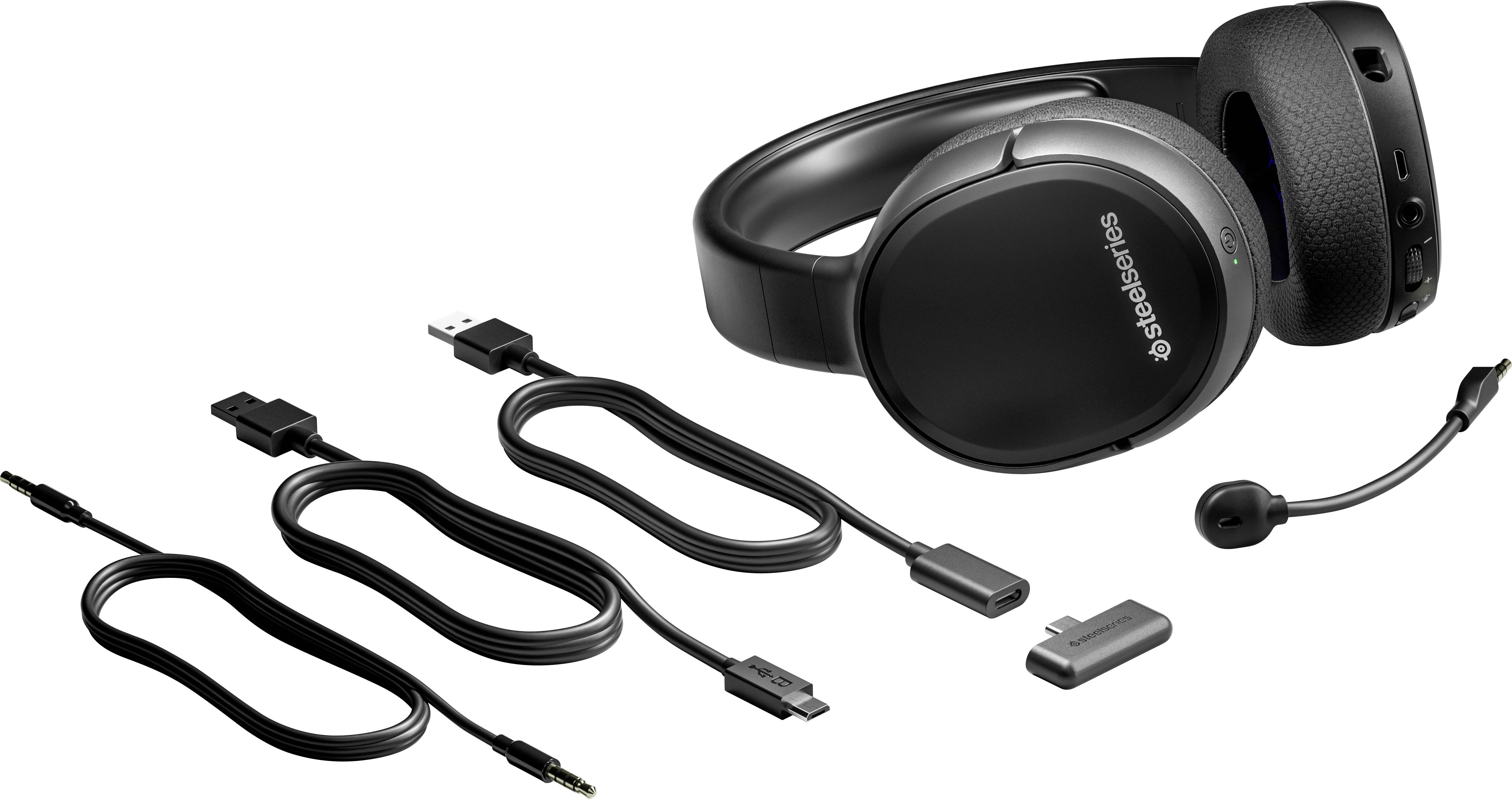Bezprzewodowy zestaw słuchawkowy z regulowanym mikrofonem obok odbiornika USB i kabli, odpowiedni do grania lub odtwarzania dźwięku.