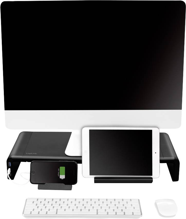 Komputer z czarną klawiaturą i białą myszą. Na stole ustawiony jest smartfon ładujący się oraz tablet.