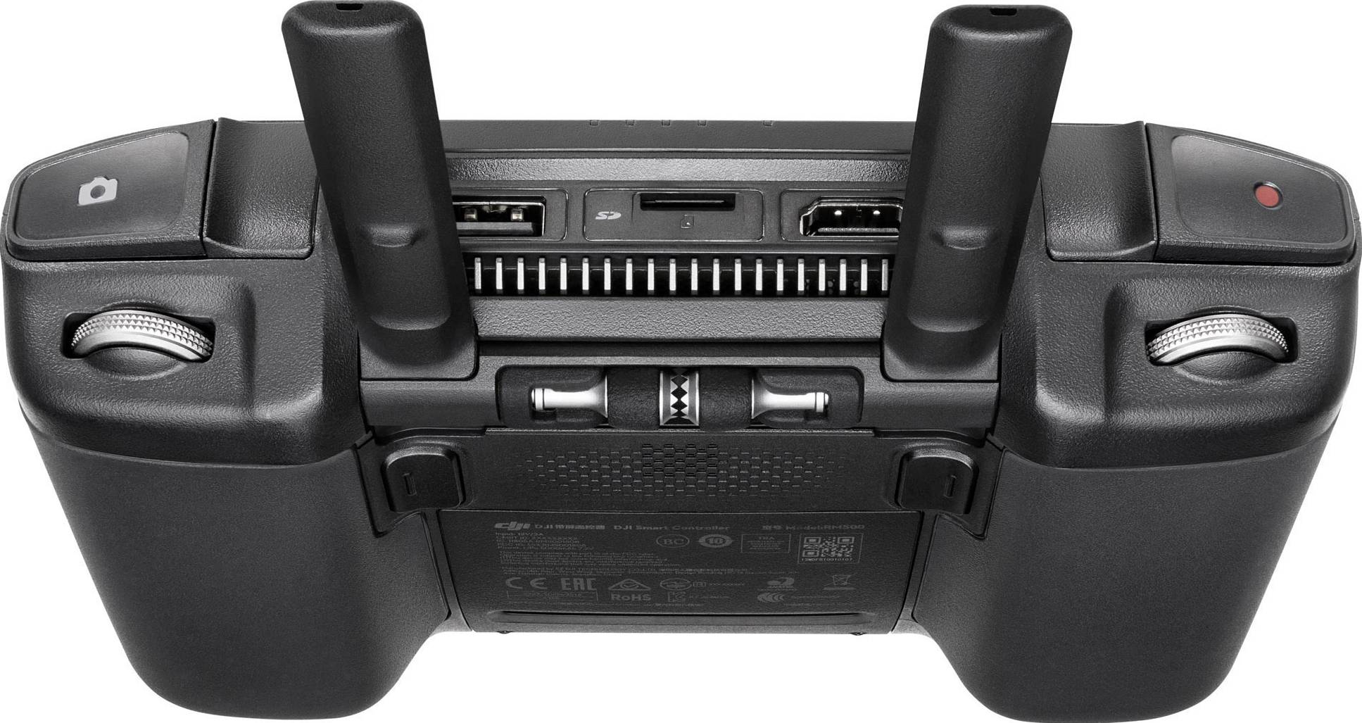 Widok z tyłu pilota zdalnego sterowania z dwiema antenami, dwoma bocznymi pokrętłami sterującymi oraz interfejsami połączeniowymi pośrodku.