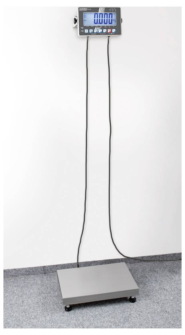 Waga z szarą platformą i cyfrowym wyświetlaczem zamocowanym na ścianie, połączona dwoma długimi kablami. Wyświetlacz wskazuje '000.0'.