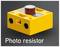 Żółta obudowa z tworzywa sztucznego z dwoma czujnikami i czerwonym przyciskiem, oznaczona napisem 'PR'. W dolnej części znajduje się napis 'Photo resistor'.
