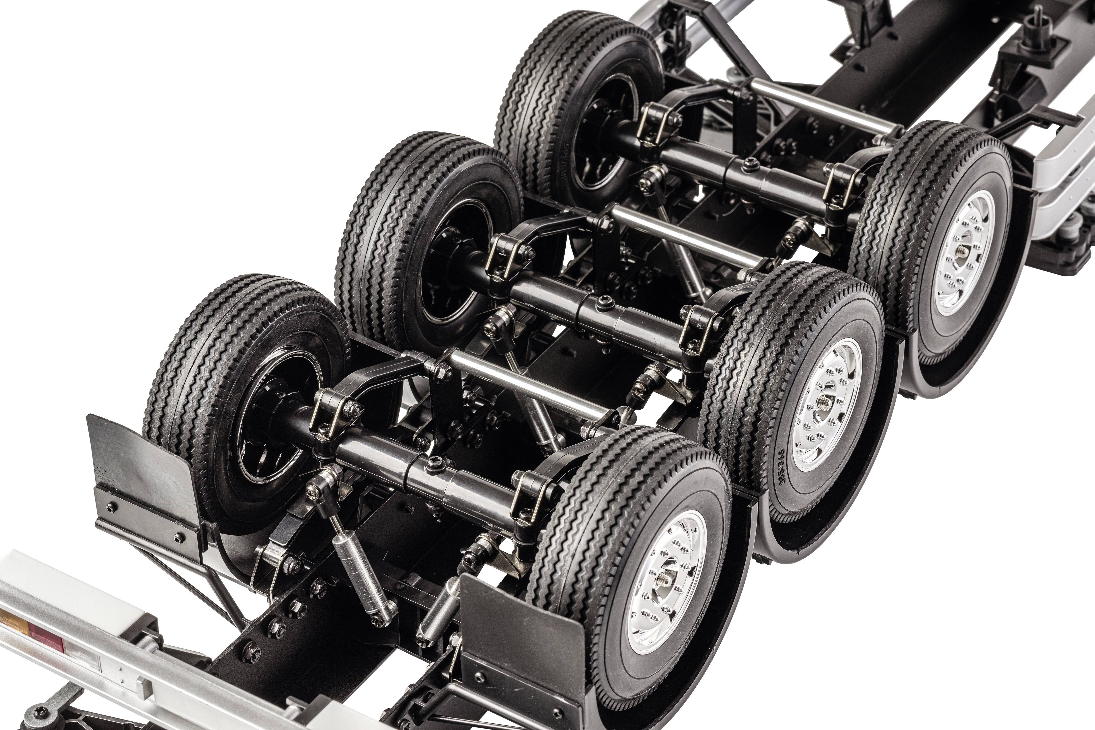 Podwozie przyczepy z sześcioma kołami, widoczne osie i zawieszenie, zamontowane w warsztacie lub na wystawie.