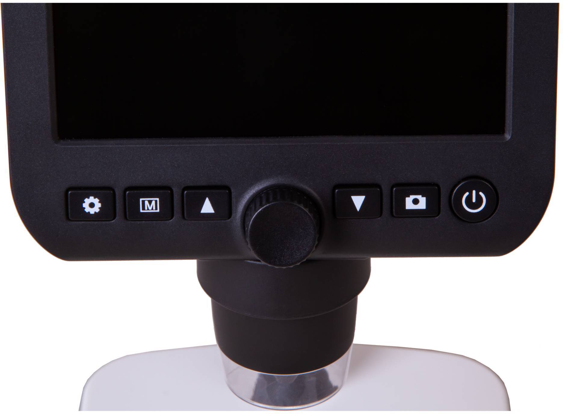 Czarno-biały ekran urządzenia z wieloma przyciskami funkcyjnymi poniżej: kołem zębatym, strzałkami, kamerą, włącznikiem/wyłącznikiem oraz pokrętłem pośrodku.