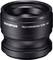 Czarny telekonwerter Olympus TCON-T01 w kształcie cylindra, zwiększający optyczny zasięg aparatów fotograficznych, widok produktu z boku.