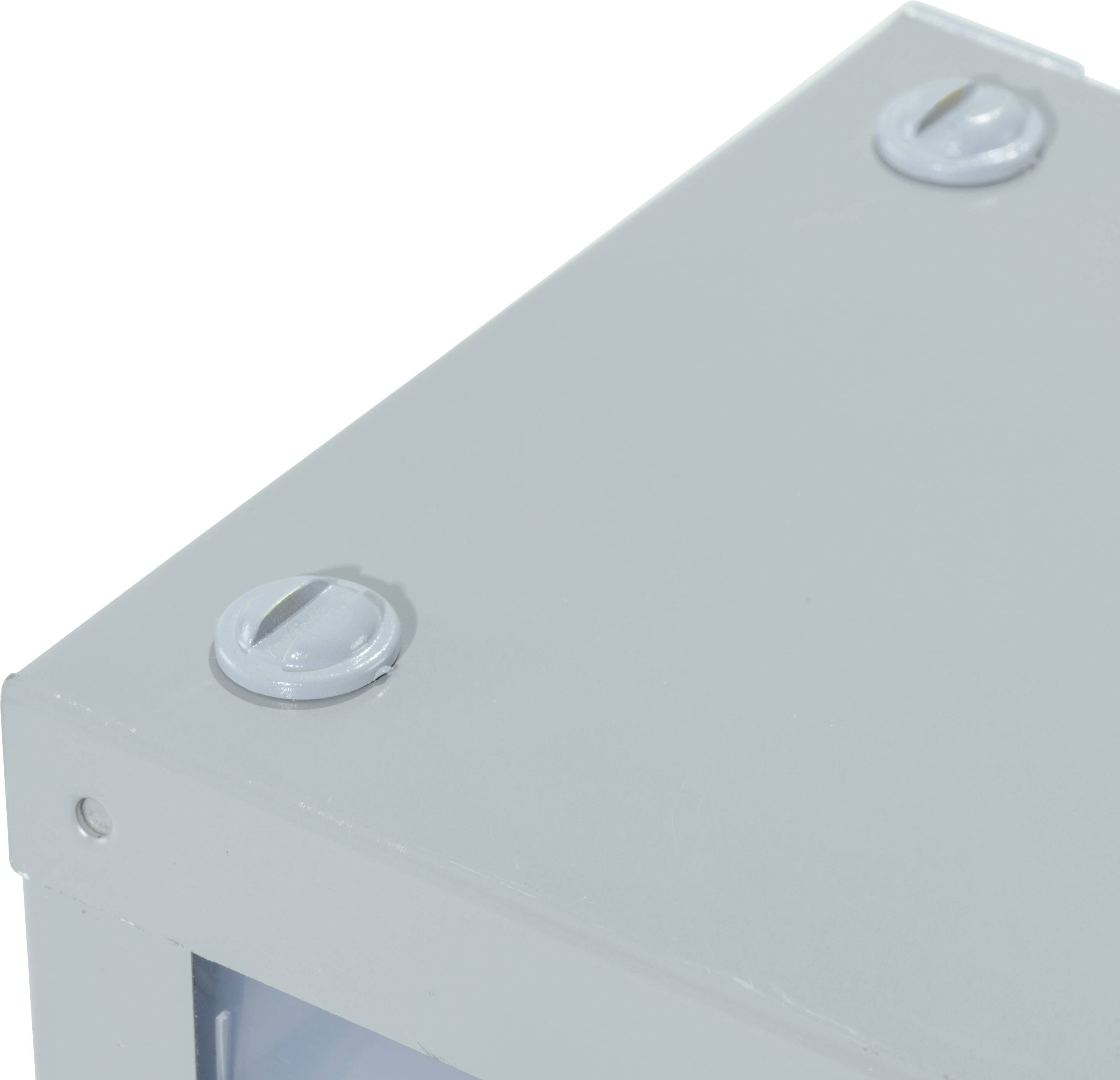 Szary, prostopadłościenny obiekt z łbami śrub w narożnikach prezentuje wierzchnią część metalowej obudowy lub skrzynki.