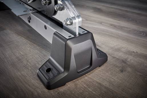 Struktura metalowa na podłodze drewnianej; element składowy urządzenia lub stanowiska montażowego.