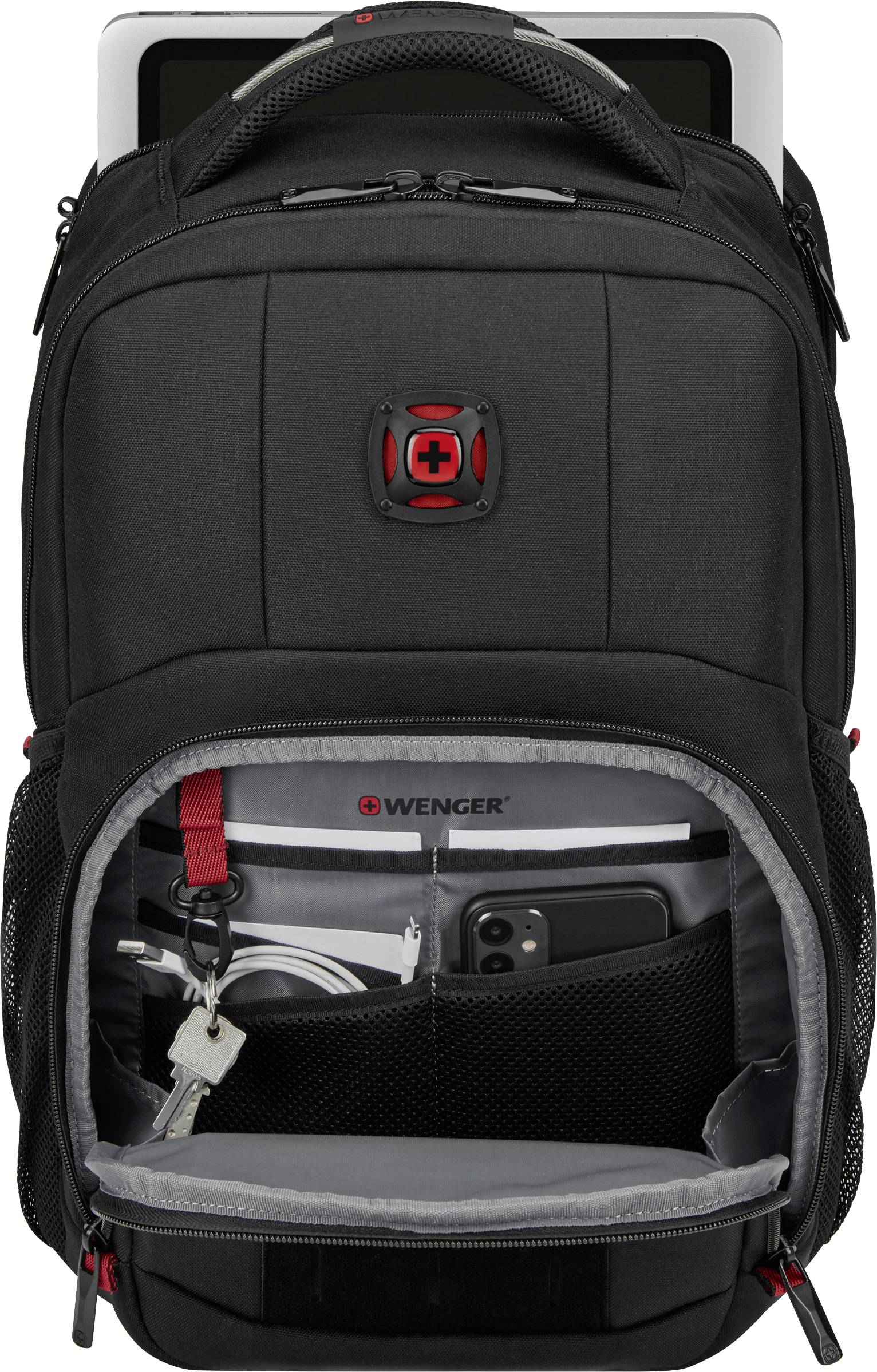 Czarny plecak z otwartą kieszenią, w której widać tablet, klucze, długopisy i smartfona. Laptop częściowo widoczny w tylnej kieszeni.